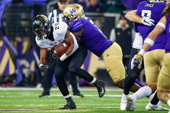 Seattle, Washington, USA; Washington Huskies defensive lineman Jeremiah Martin (3) tackles Colorado Buffaloes running back Deion Smith (20) during the second quarter at Alaska Airlines Field at Husky Stadium.